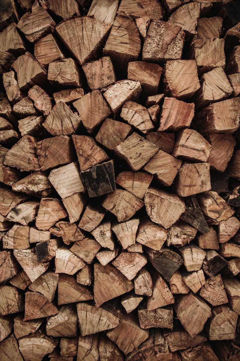 background image of a stacked pile of firewood